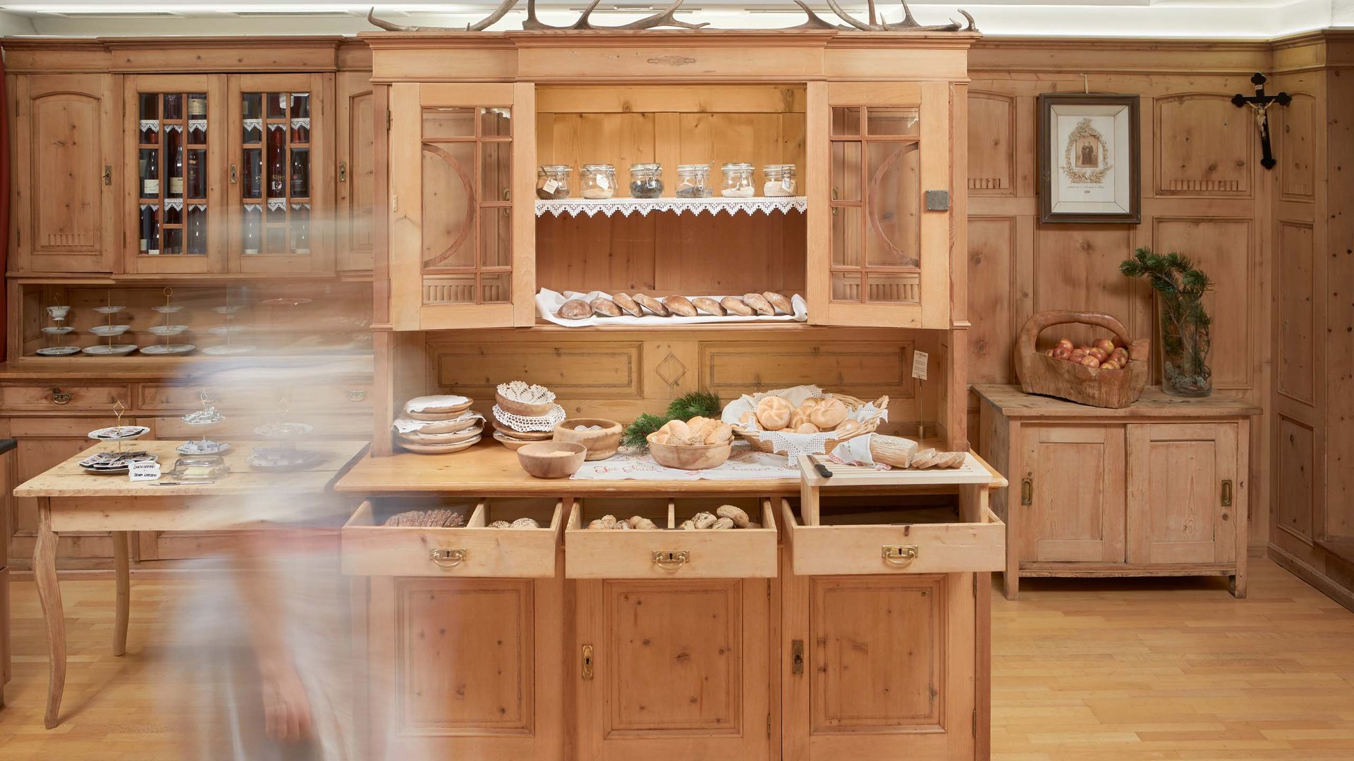 Rustic breakfast buffet at Hotel Bella Vista featuring a range of local delicacies, presented in a traditionally designed wooden kitchen.